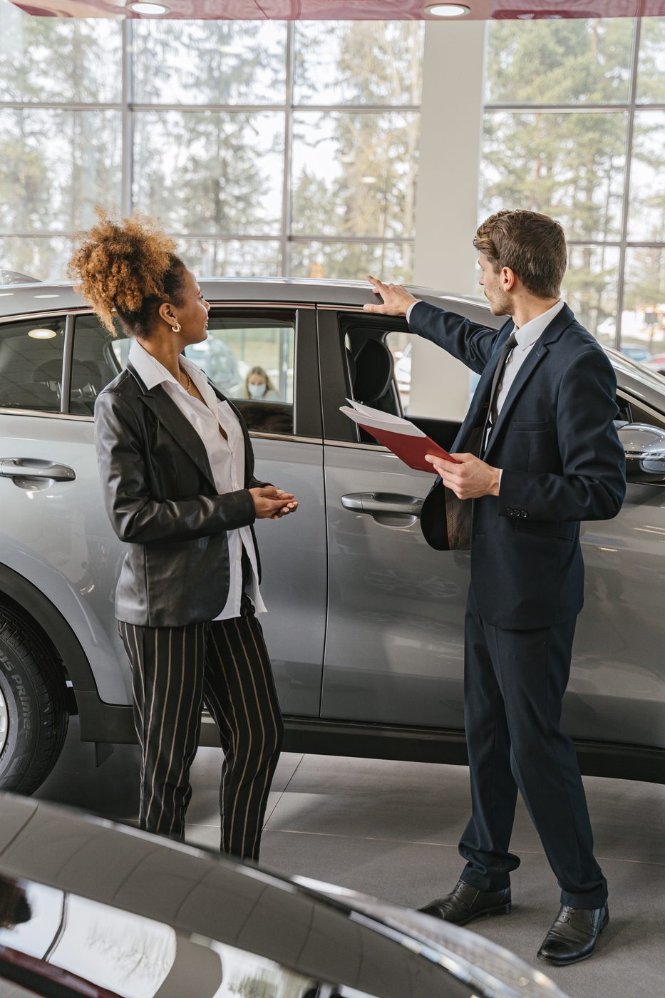 Dealer consultation inside a modern showroom.