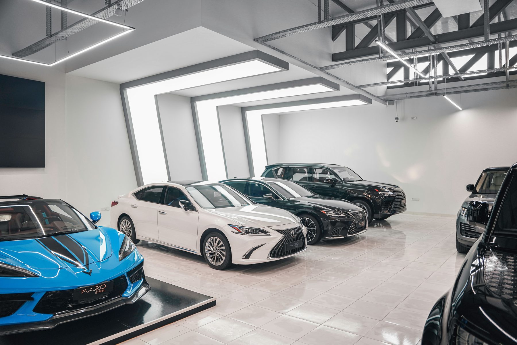 Luxury vehicles displayed in a modern showroom.