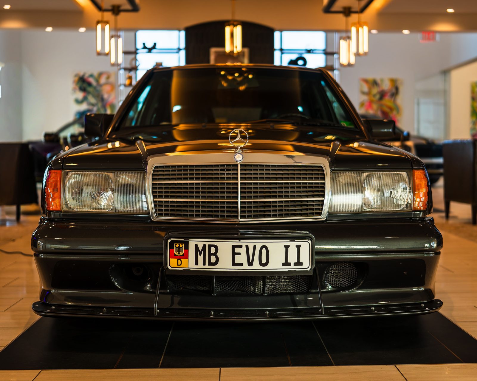 Front view of a luxury vehicle in a dealership showroom.